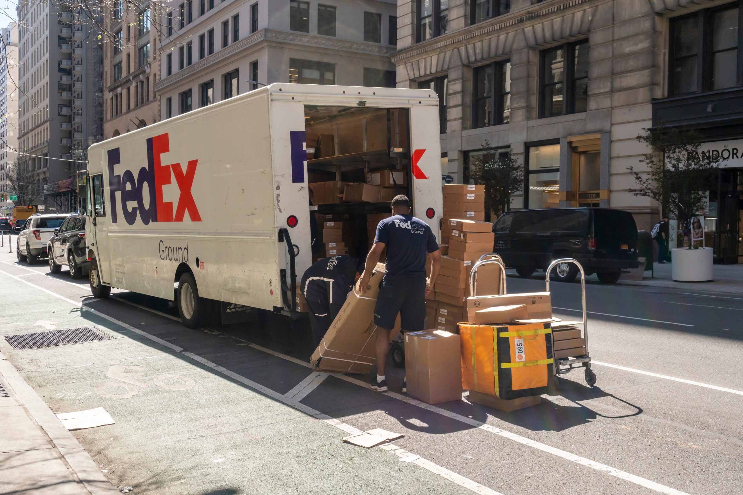FedEx driver delivering large additional handling packages