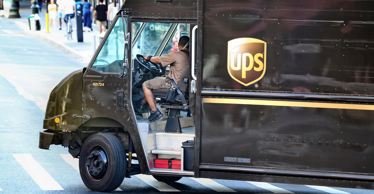 UPS truck driver turns a around a street corner