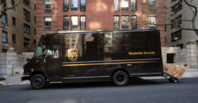 UPS truck with a full handtruck hanging off the back of the truck