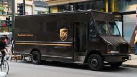 UPS truck parked on a busy street corner
