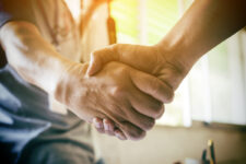 Close-up of a handshake, respresenting the most recent 2023 UPS-Teamsters contract agreement