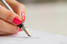 Woman signing a guaranteed service refund contract